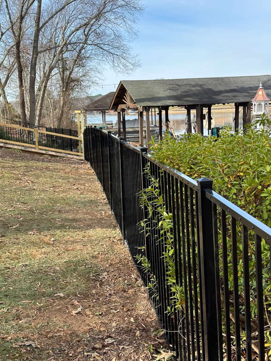 black aluminum fence installed on lake property by Francis Brothers LLC