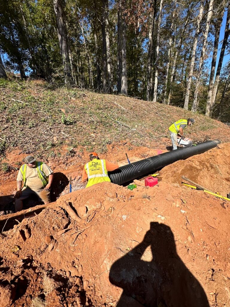Francis Brothers LLC crew working on a utility contractor job installing a new pipe.